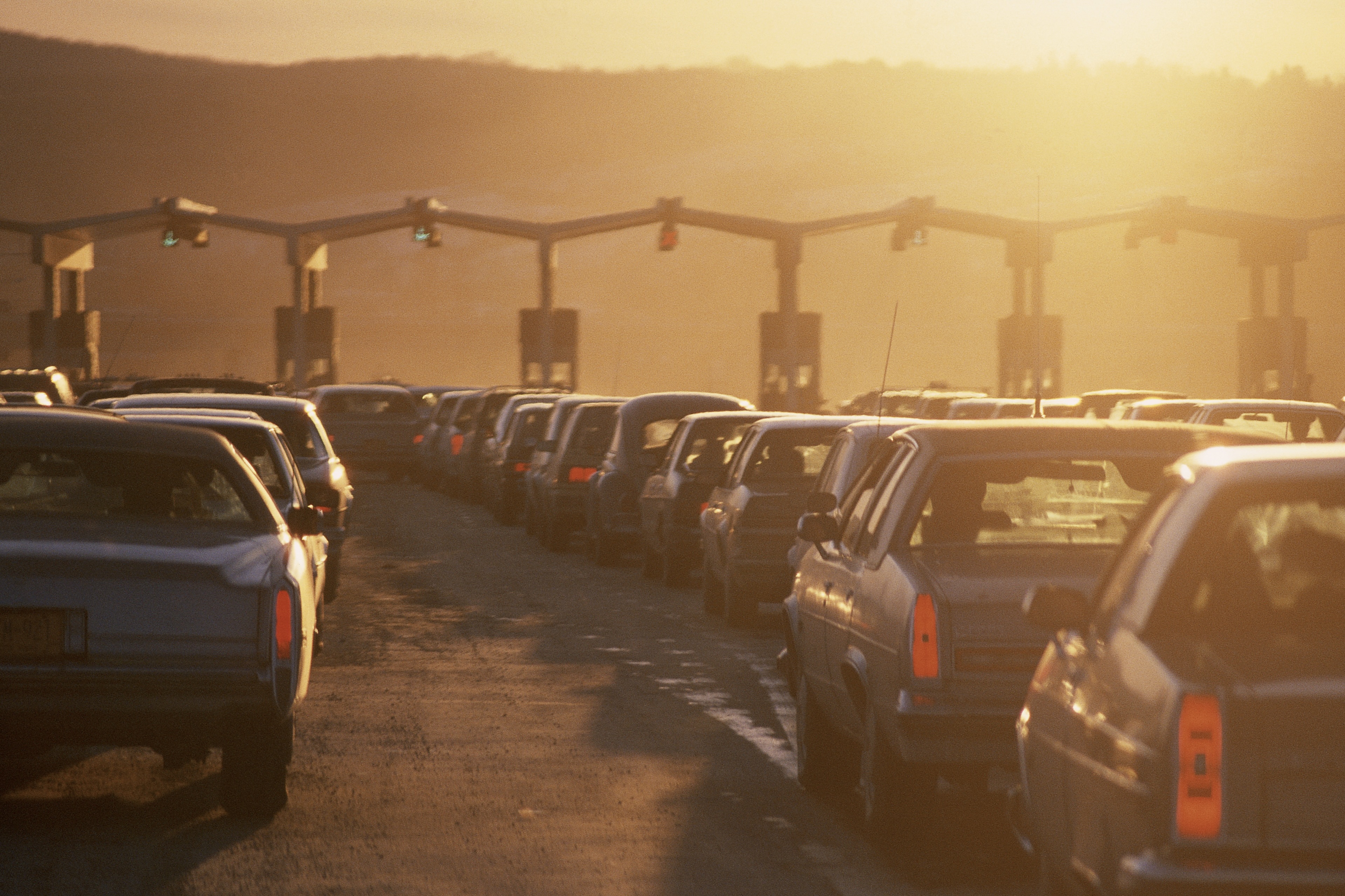 cars waiting at tollbooth
