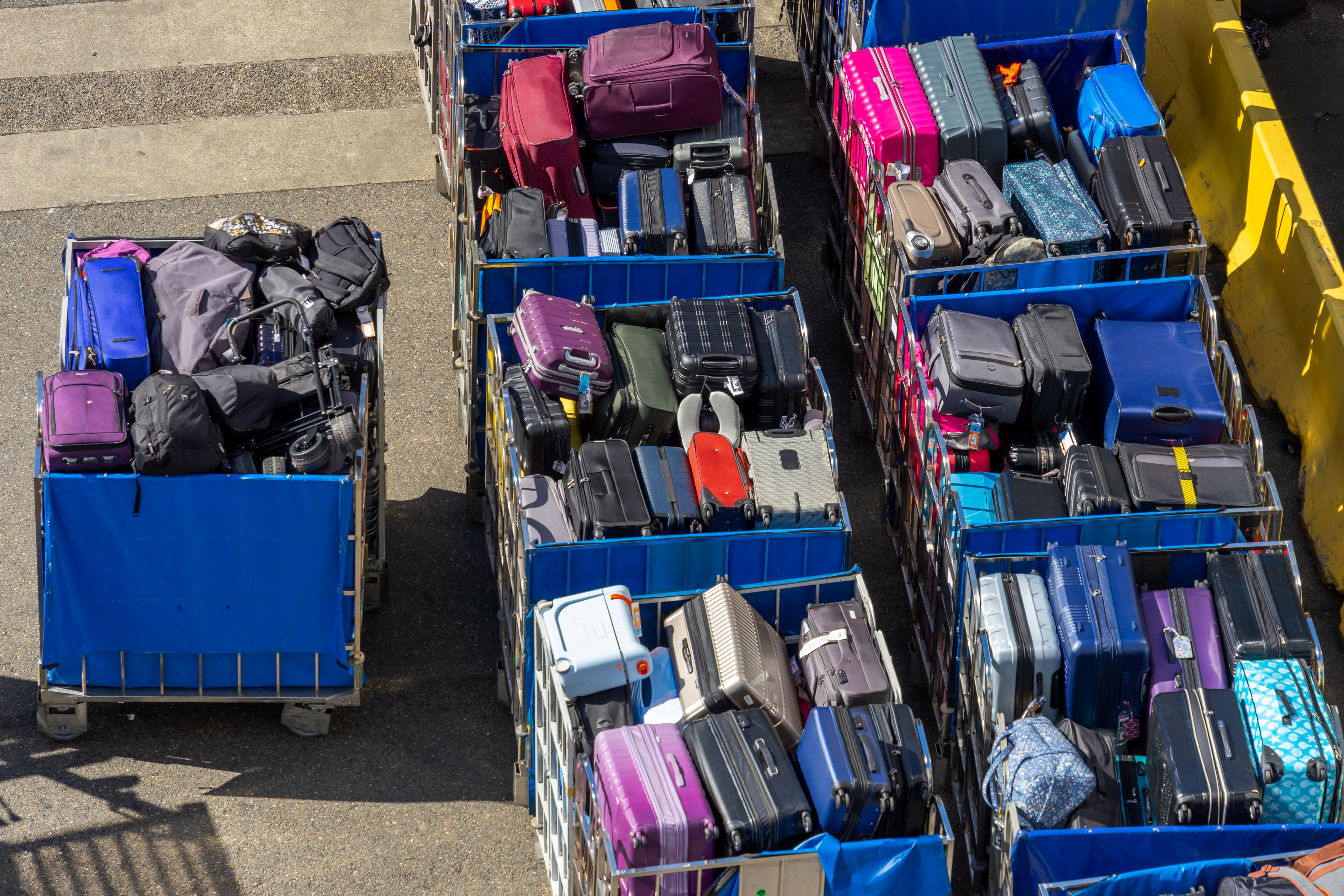 Trolleys full of luggage at a cruise terminal