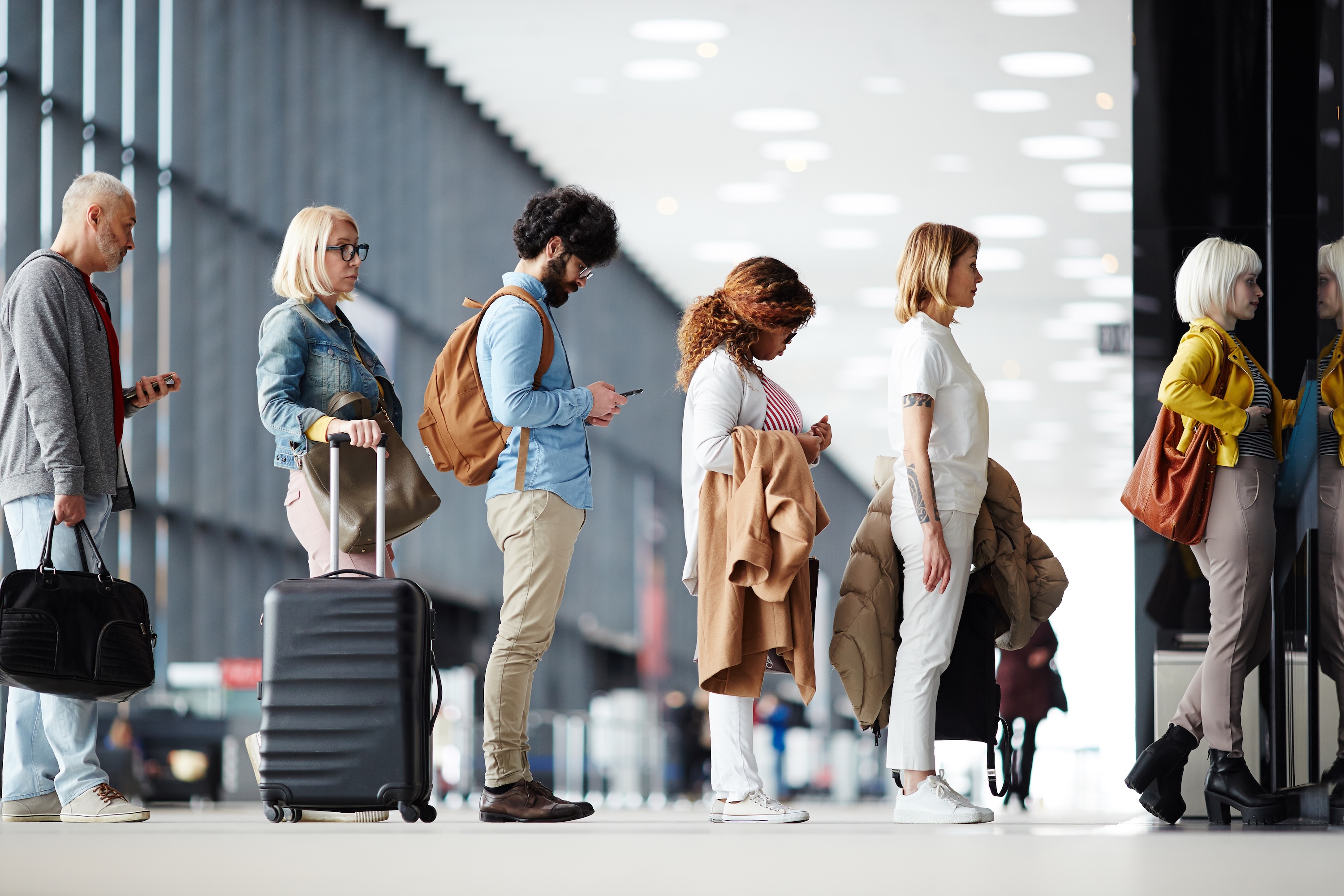 Line of travelers at airport