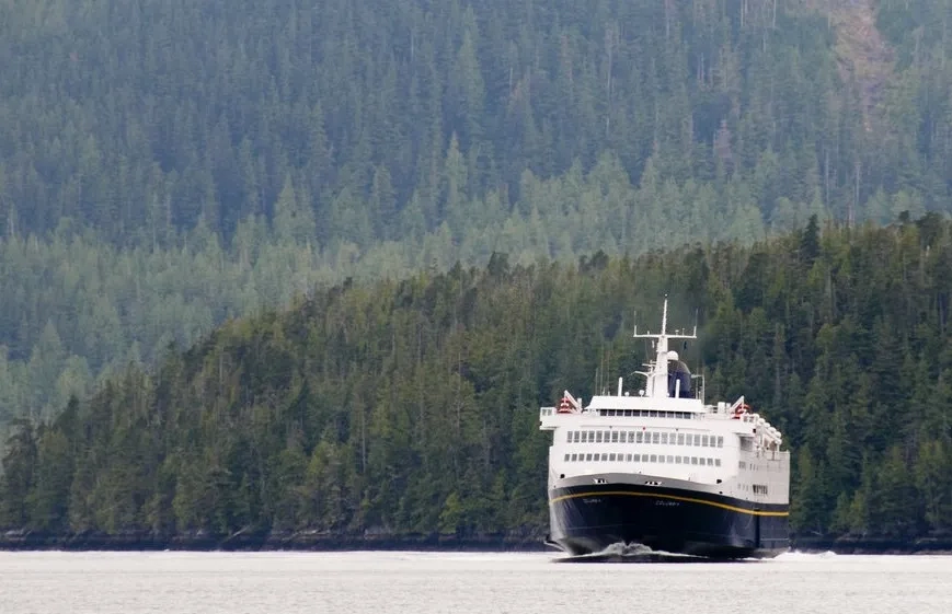 Ferry in front of forest mountains, Alaska Marine Highway System