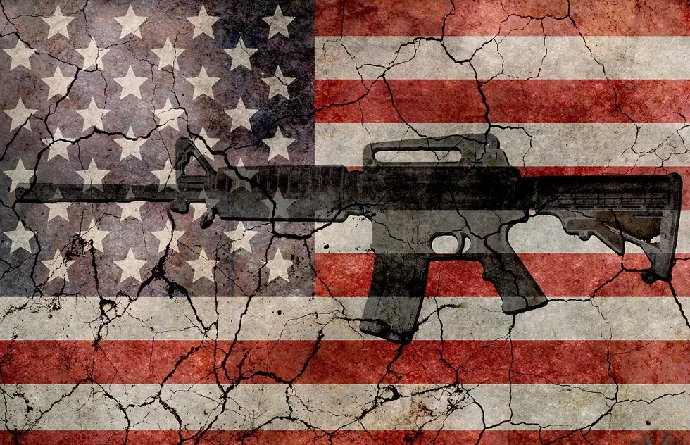 Automatic rifle on cracking American flag