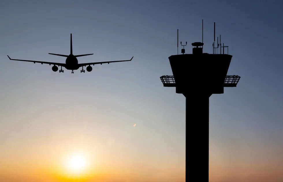 An airplane and airport control tower