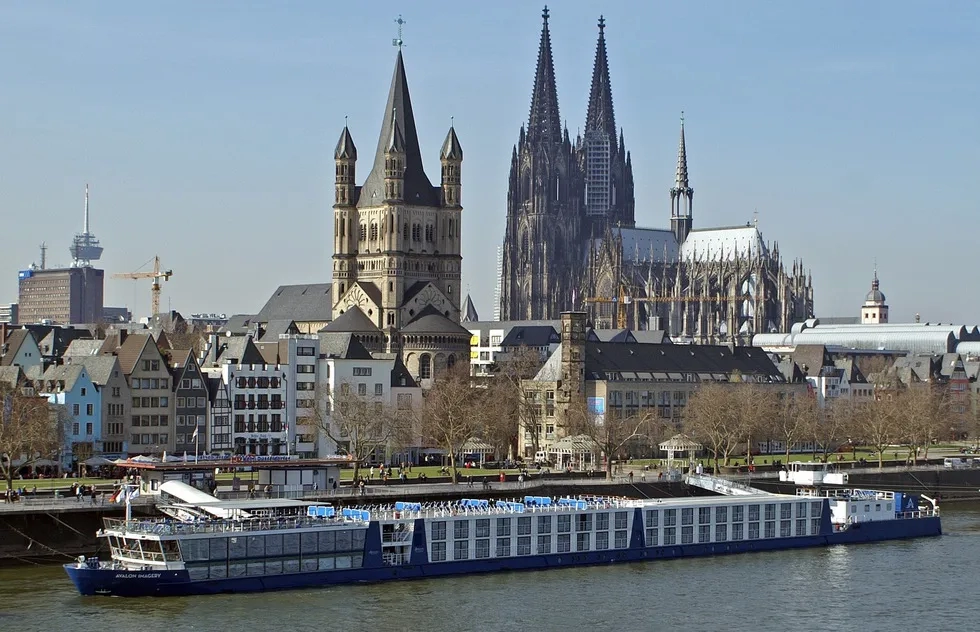 A river cruise ship glides by Cologne in Germany
