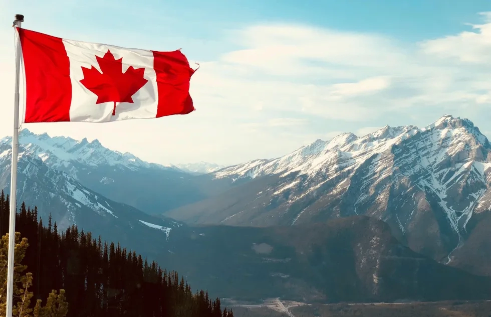 Canada flag in front of Banff National Park in Alberta
