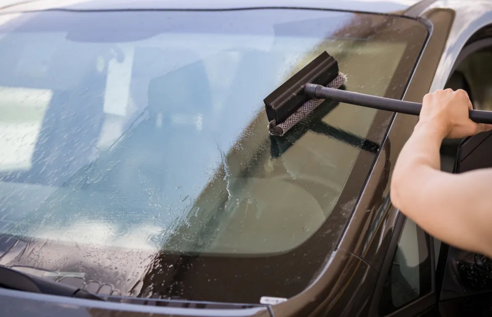 Squeegeeing a car windshield