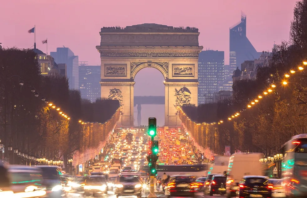 Night view of the Arc de Triomphe from the Champs-Élysées in Paris