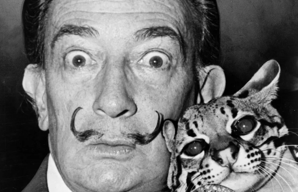 Salvador Dalí mugs for the camera with an ocelot
