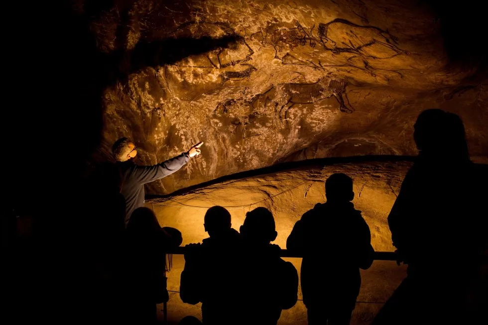 visitors in Grotte de Niaux cave, France