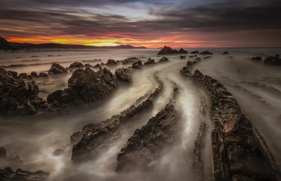 Sunset over an otherworldly beach in Spain's Basque Country