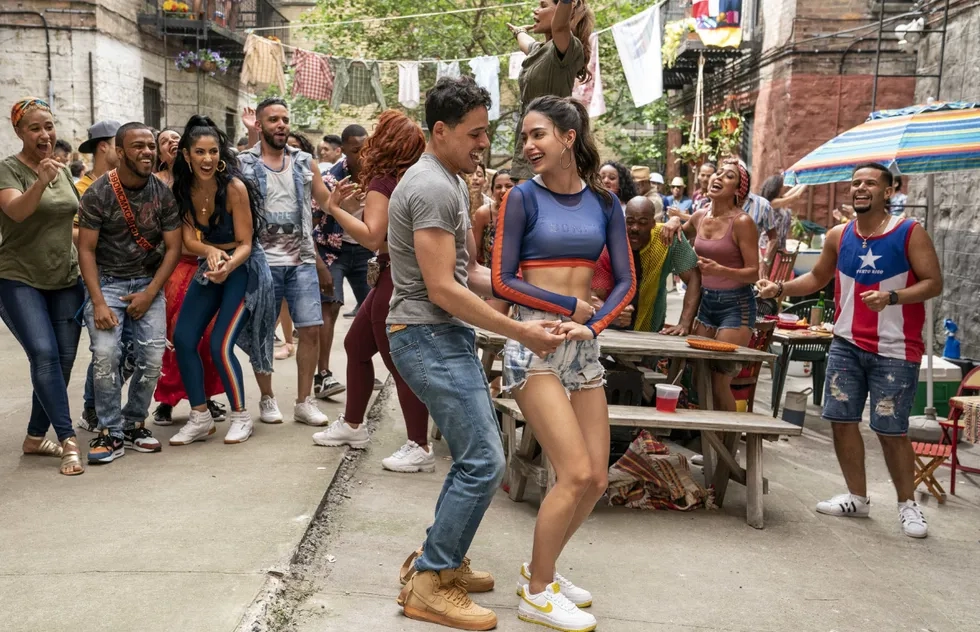 (Left Center-Right Center) ANTHONY RAMOS as Usnavi and MELISSA BARRERA as Vanessa in Warner Bros. Pictures’ “IN THE HEIGHTS,” a Warner Bros. Pictures release. Photo by Macall Polay
