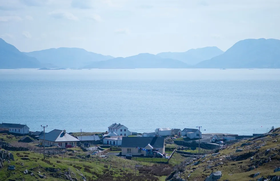 A few scattered houses amid mountains and water on the Irish island of Inishturk off the coast of County Mayo