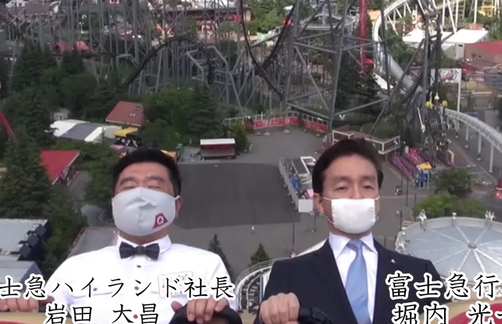 Masked executives ride the Fujiyama roller coaster at Japan's Fuji-Q Highland amusement park.