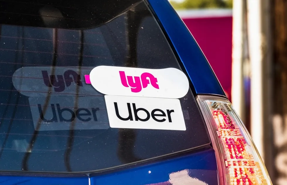 Lyft and Uber stickers on a car