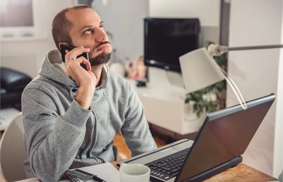 Frustrated man waiting on the phone