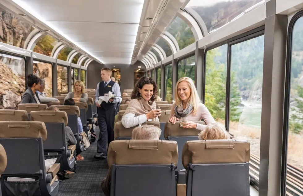 Rocky Mountaineer viewing car with passengers and waiter