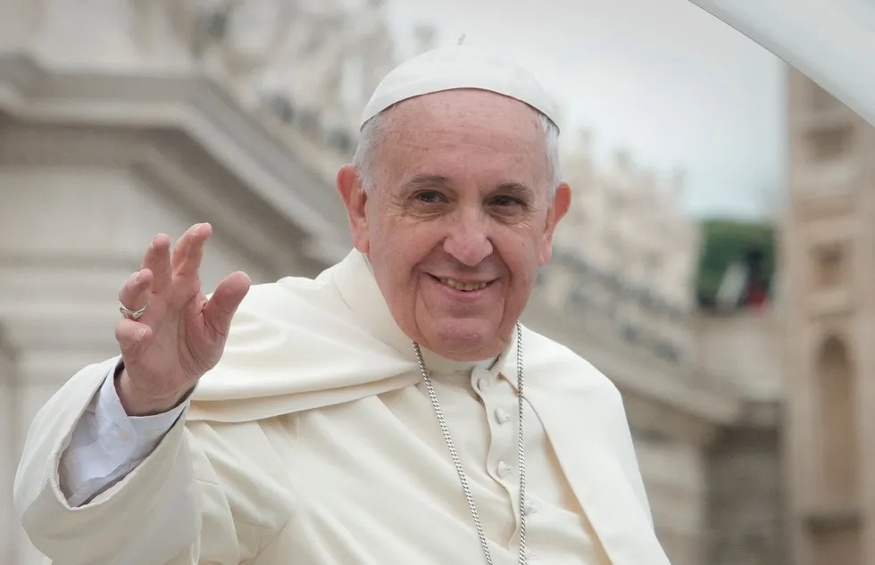 Pope Francis waves to supporters.
