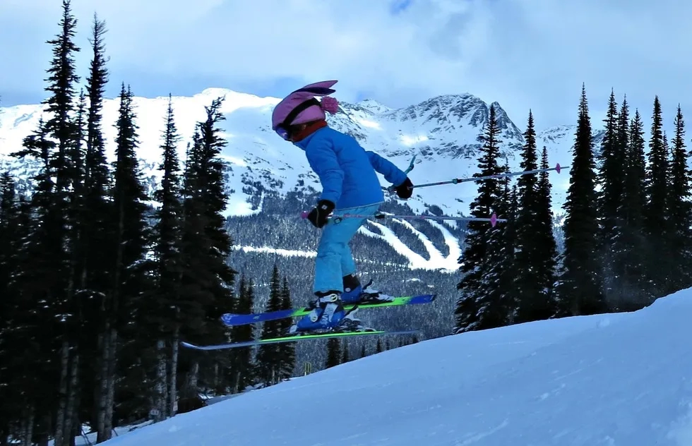 A young skier flies through the air at Whistler/Blackcomb