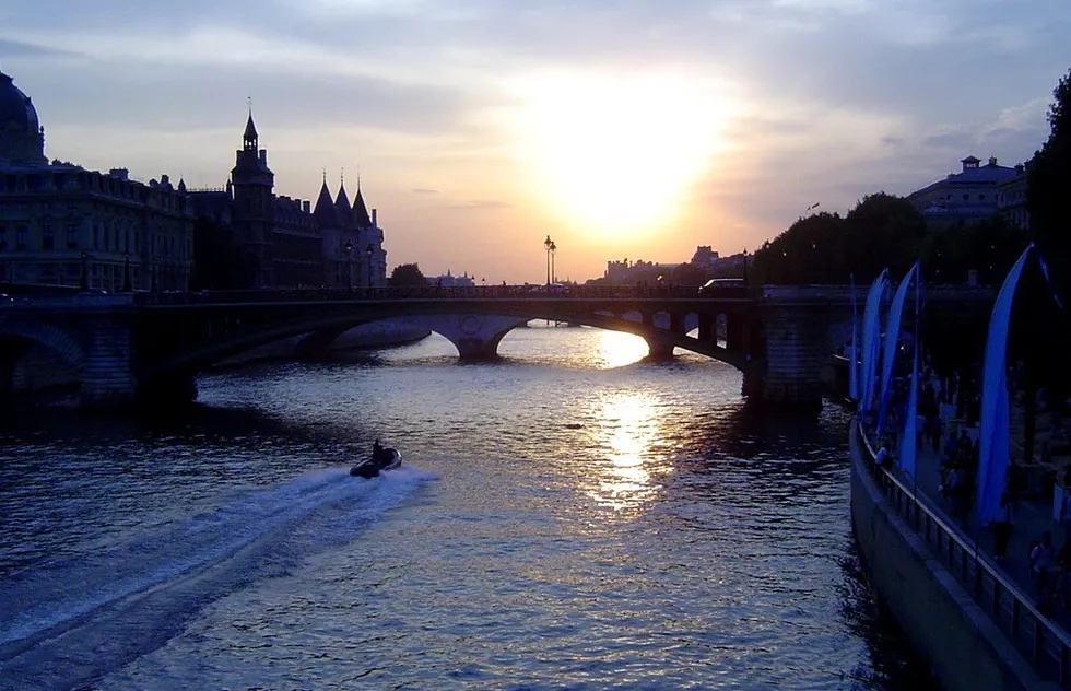 The Seine cuts through Paris at sunset