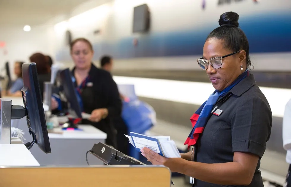 Ticket agent at American Airlines inspecting documents