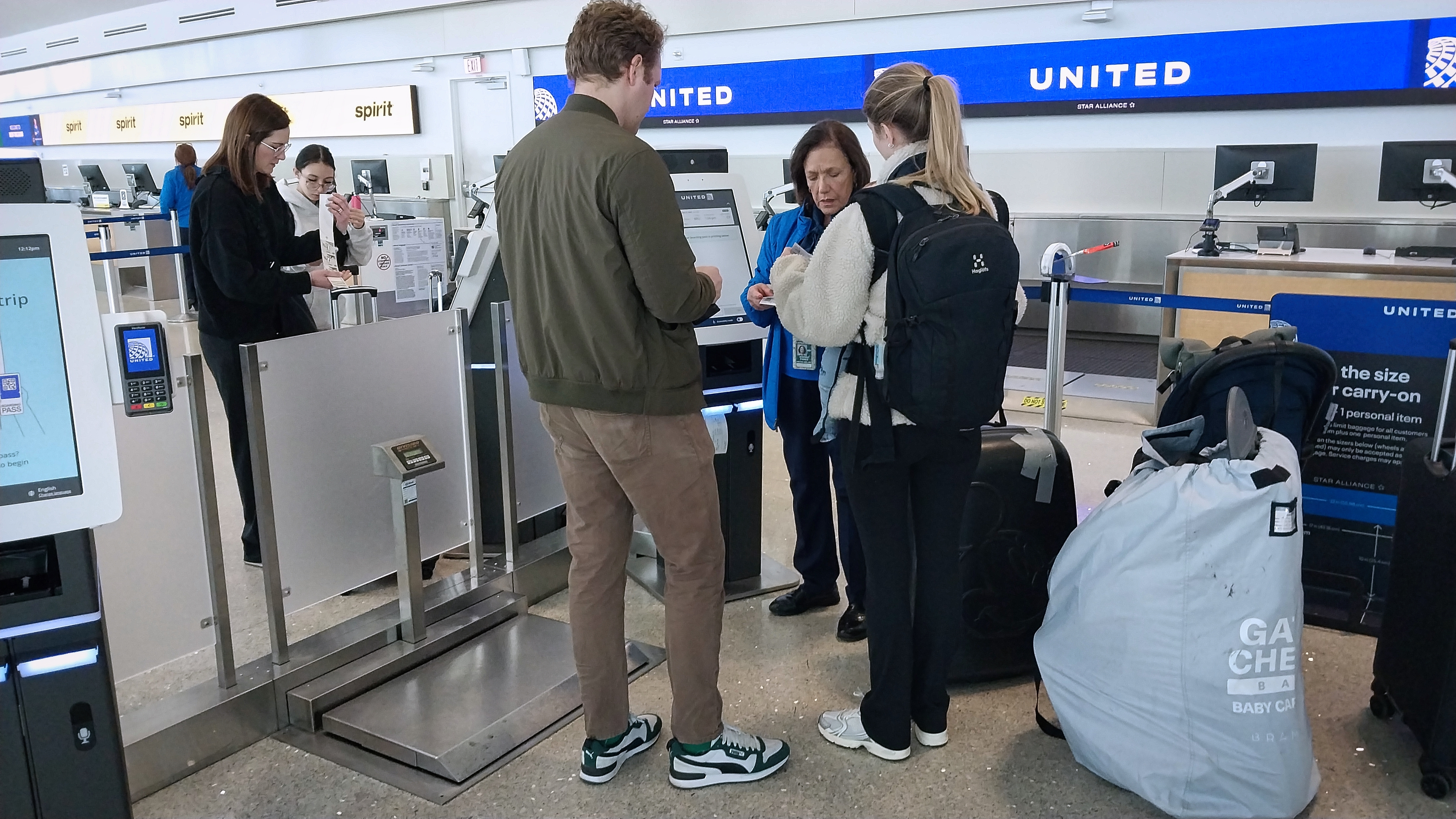 Departing United Airlines passengers check luggage at the ticket counter inside Louis Armstrong Airport