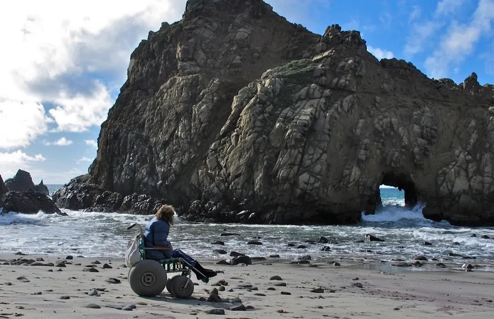 Woman in a beach wheelchair in California
