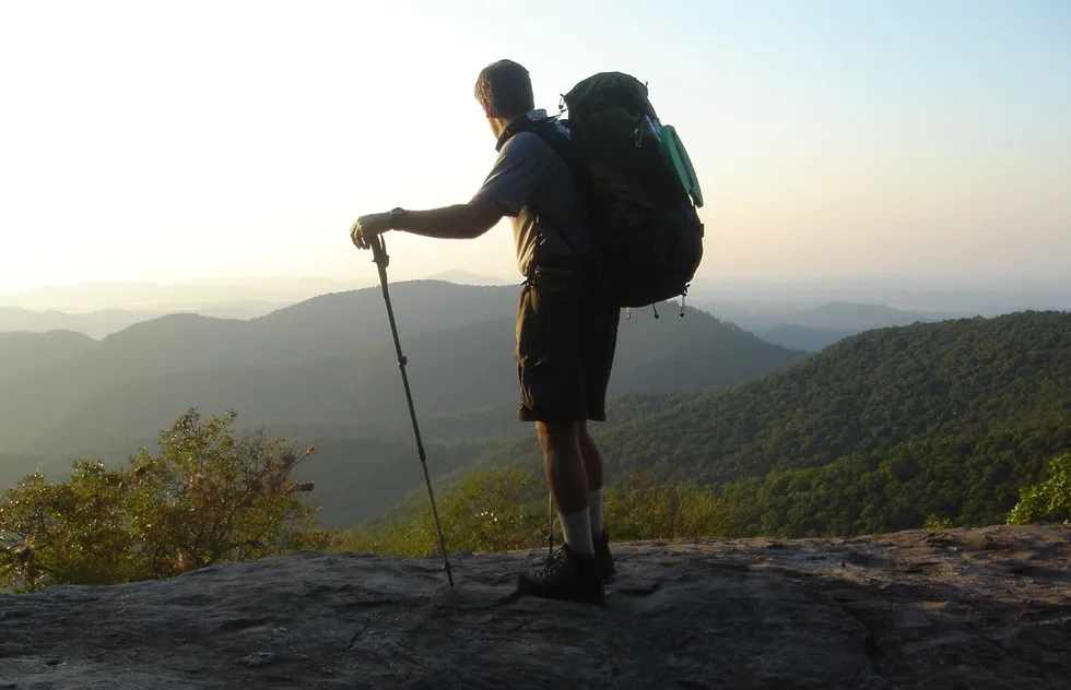 Appalachian Trail hiker (male) at viewpoint at dusk