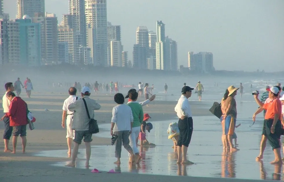Asian tourist crowd on beach in Brisbane, Australia