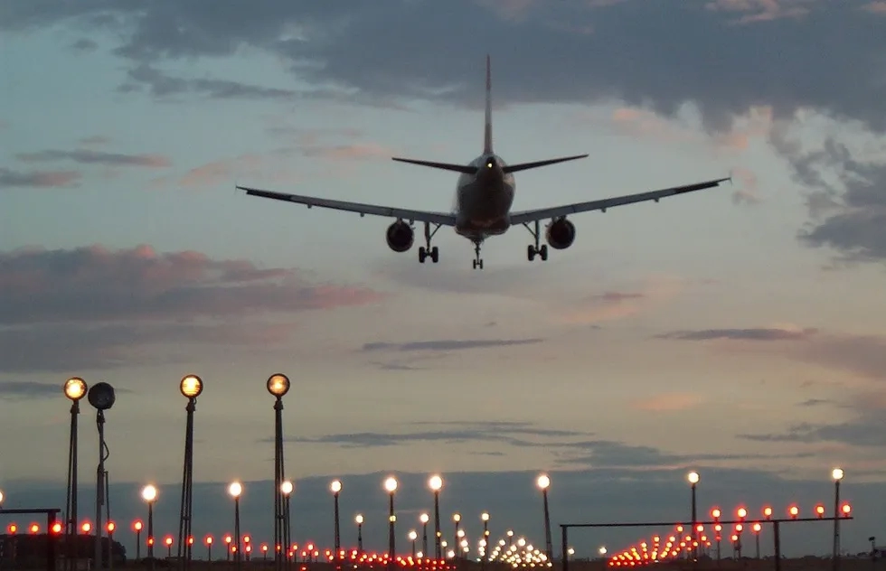 Airplane flying over runway