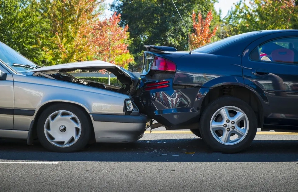 two cars crash, crumpled bumpers