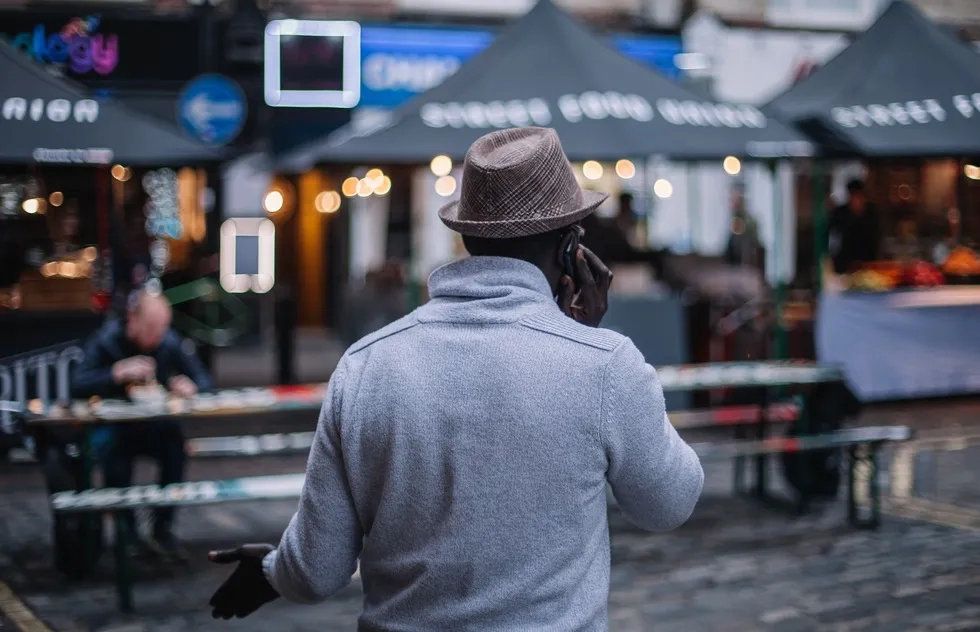 Man on phone outside restaurant