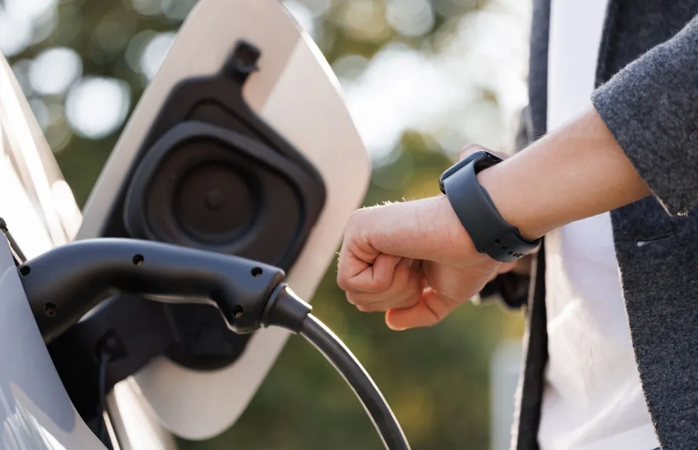 electric vehicle charger with hand and smartwatch