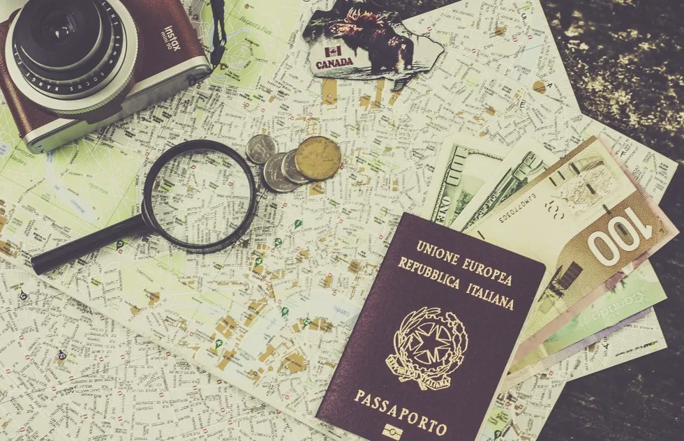 magnifying glass on map with passport and money