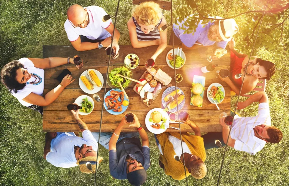 friends dining at outdoor table together, overhead shot