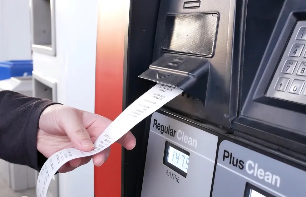 fuel receipt coming out of gas station pump