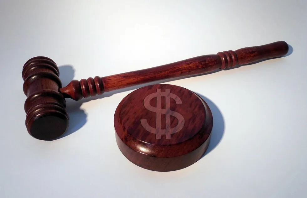 judge's gavel with dollar sign