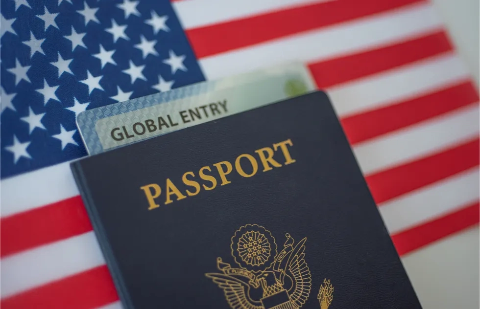 U.S. passport, Global Entry card on American flag