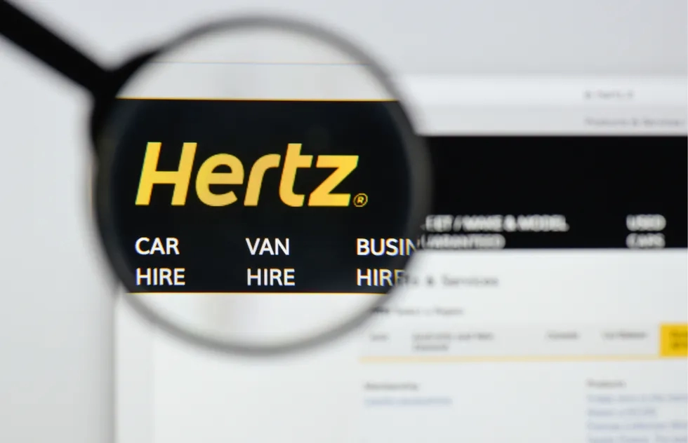 Hertz logo on its website under magnifying glass (illustration)
