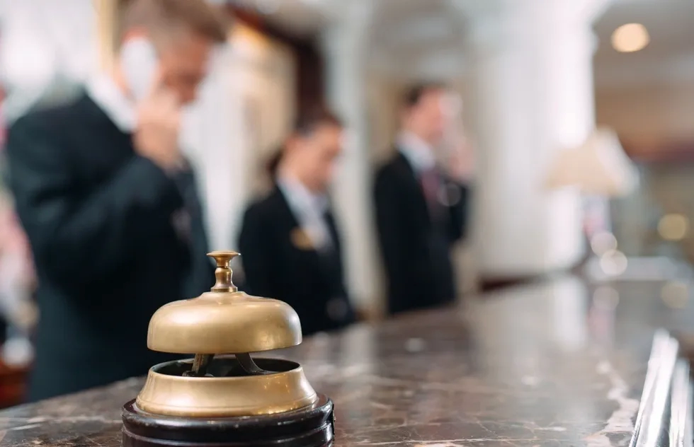 hotel front desk with staff (faces blurred)