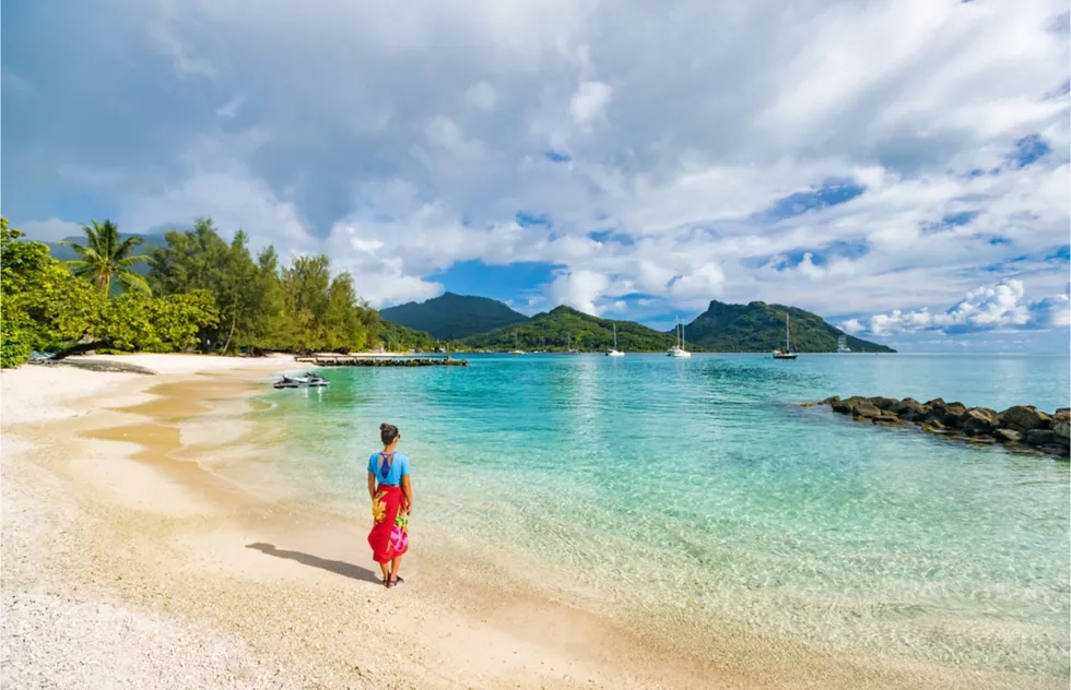 woman in sarong on beach in Huahine, French Polynesia