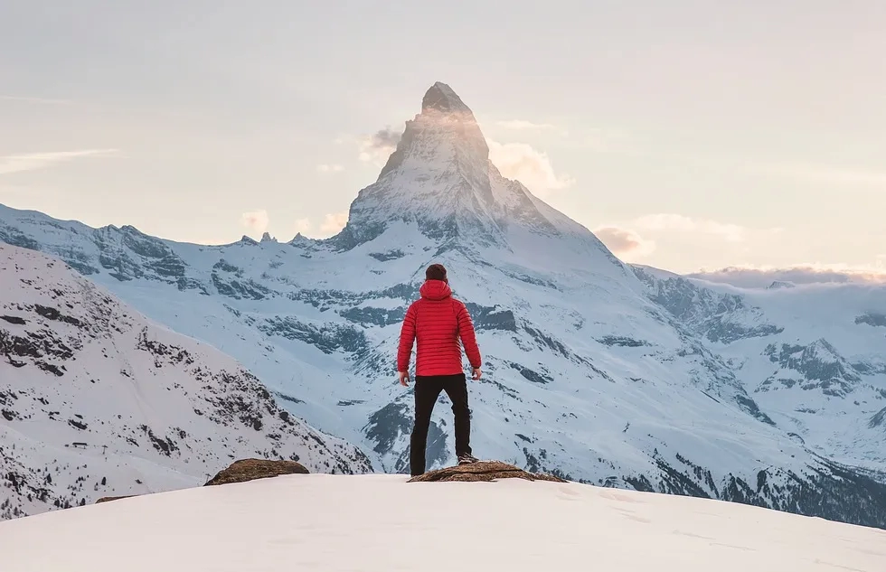 Hiker beholds the Matterhorn from afar in winter