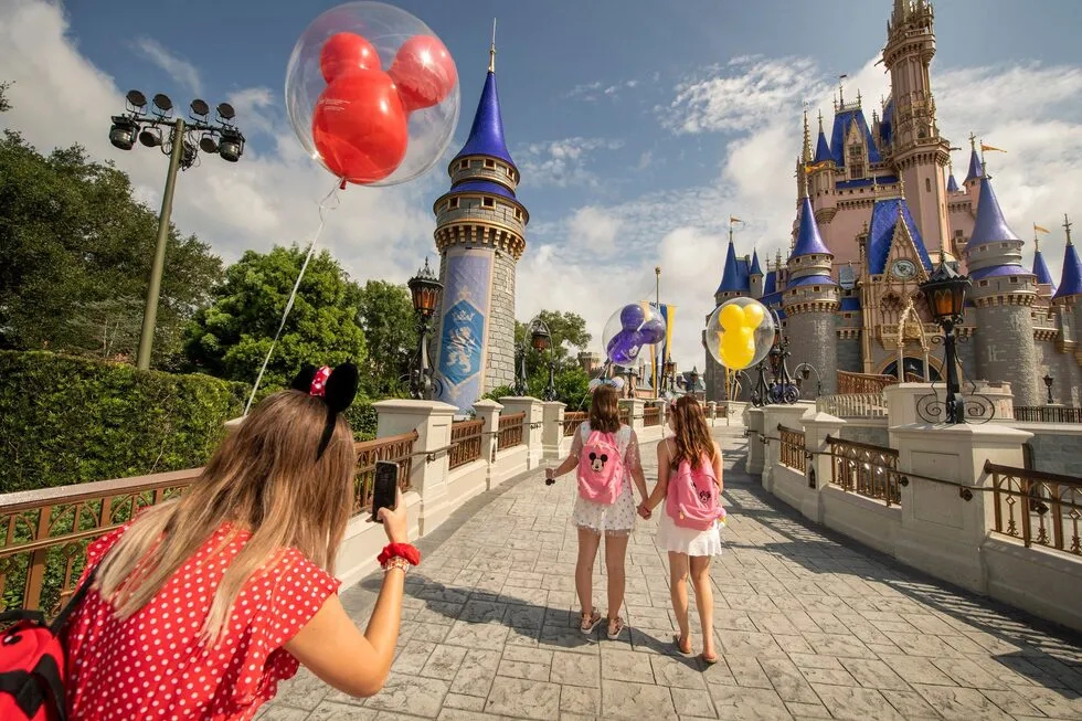 tweens with Mickey balloons at Cinderella Castle at Magic Kingdom, Walt Disney World