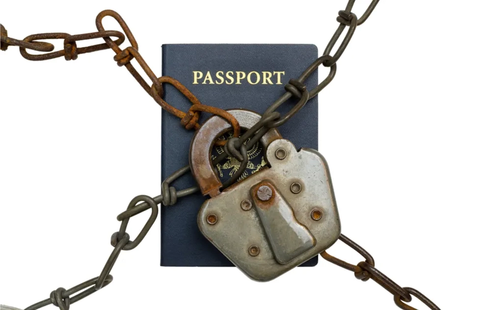 United States passport behind lock and chains