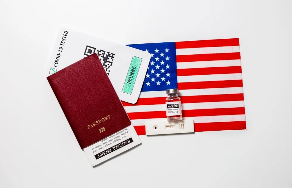 Passport, covid test, vaccine vial, united states flag