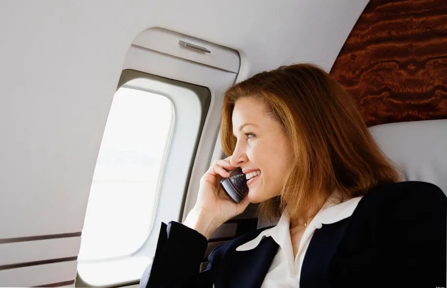Woman on mobile phone on airplane