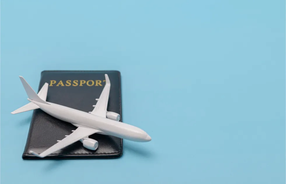 model of plane resting on blue passport