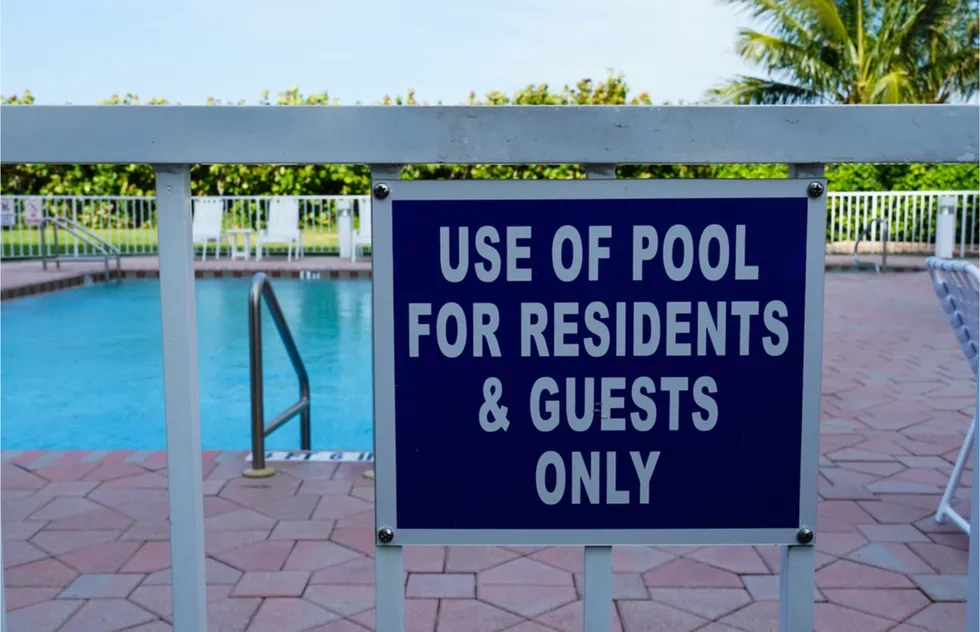 "residents and guests only" sign at pool