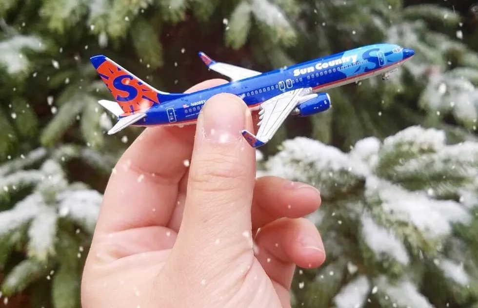 Sun Country Airlines toy plane in hand