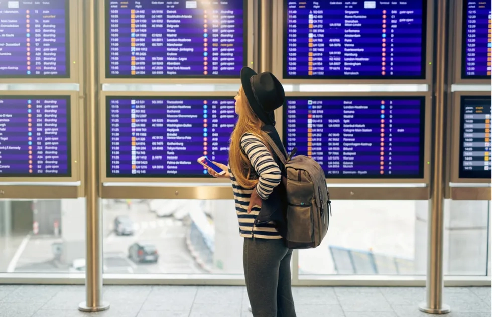 Checking the flight schedule at an airport