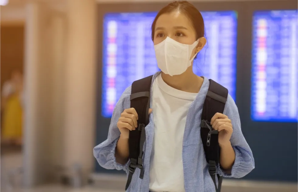 woman with medical face mask at airport