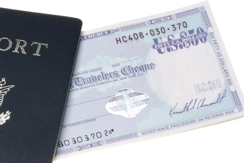 traveler's check and edge of U.S. passport